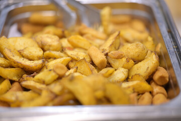 Delicious golden seasoned potato wedges ready to eat