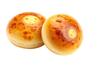 Two golden-brown, baked buns with creamy centers and slightly charred tops