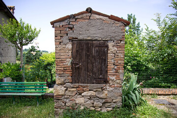 Medieval well in the village of the Castle of Serravalle. Valsamoggia countryside, Bologna, Italy.