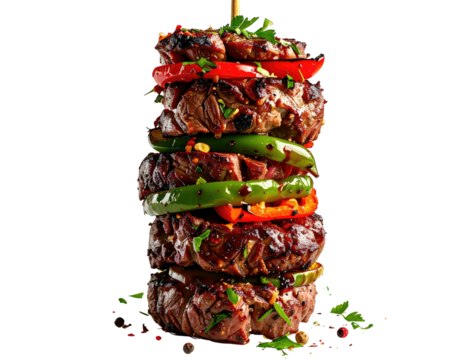 Skewered grilled steak and pepper stack against black, edible, colorful layers