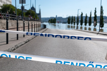 Obraz premium Police Tape at Flooded Riverbank Near Parliament