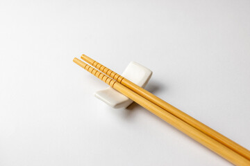 Two Bamboo Chopsticks on Porcelain Holder