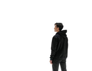 A person with dark hair, wearing a black hoodie and pants, is turned to the right. The background is solid black