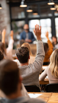 Classroom workshop training seminar audience learning education raised hand question discussion lecture student adult group teamwork participation