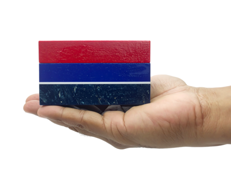 A person's hand, against a stark black background, cradles a stacked collection of colorful rectangular blocks - Powered by Adobe