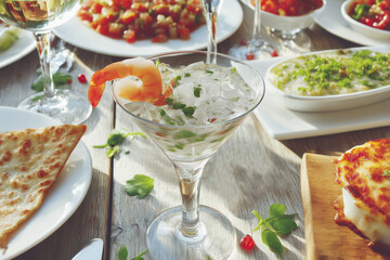 Shrimp cocktail in a martini glass, in the ice. Serving chilled shrimp cocktail in a restaurant