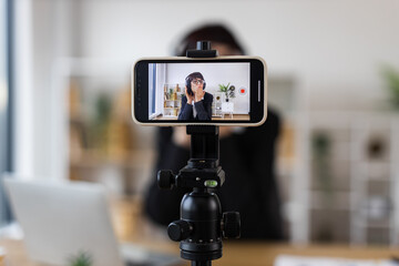 Caucasian woman at workspace recording blog about relaxation techniques, dancing, listening music.