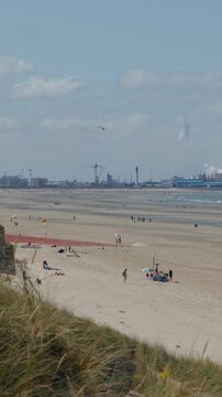 Panning View of Dunkirk Beach with Distant Industrial Port