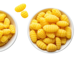 Two white bowls, brimming with yellow, ridged pasta, against a black background