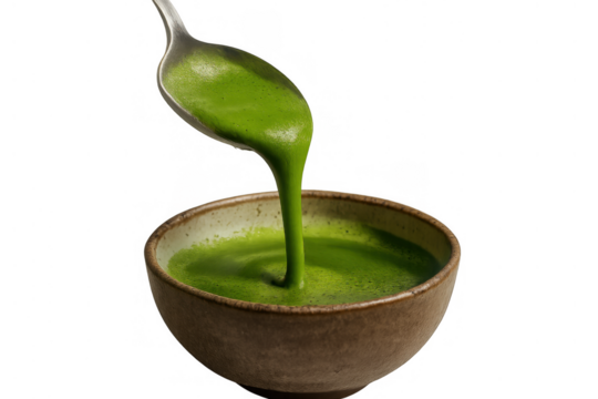 Pouring green matcha tea into a ceramic bowl, preparing a healthy japanese beverage, transparent background
