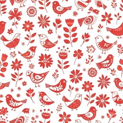 A vibrant pattern featuring stylized red and white birds, flowers, and leaves arranged in a whimsical, repetitive design suitable for textiles or decorative backgrounds