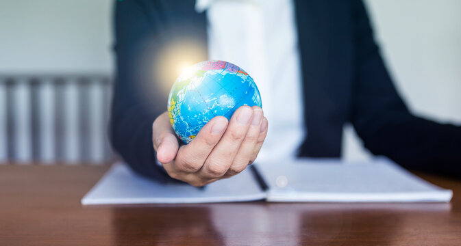 Business girl holding globe with flare light, business people holding globe, global marketing, Business development technology to support creativity idea