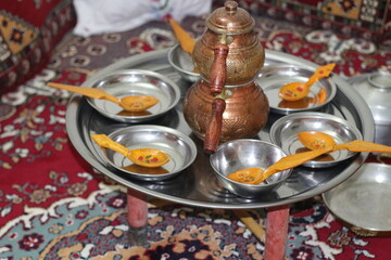 Wooden and copper tools used for dining and the table set up in a village house in Anatolia