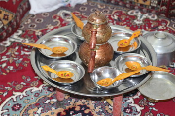 Wooden and copper tools used for dining and the table set up in a village house in Anatolia