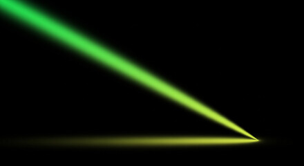 A green light beam shines diagonally down onto a yellow surface in the darkness.