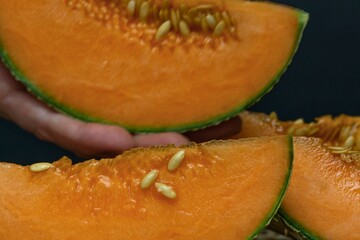 Close up of ripe cantaloupe slices with seeds visible