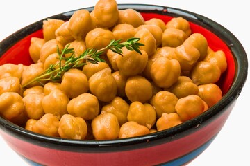 Bowl of healthy chickpeas garnished with fresh thyme