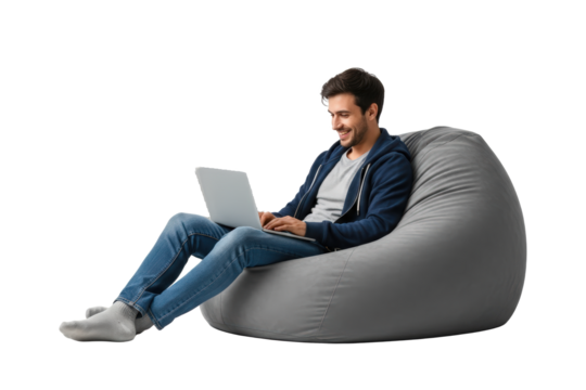 Smiling Man In Blue Hoodie And Jeans Sits On A Grey Bean Bag Chair Working On A Laptop Computer Isolated On Transparent Background
