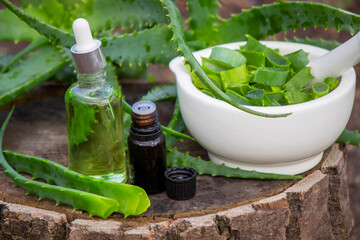 Aloe Vera Home Remedy: Preparation of medicine with leaves in a mortar and essential oil.