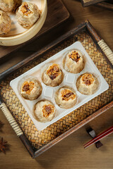 Handmade Chinese Shumai Dumplings in Bamboo Steamer for Traditional Morning Dim Sum Tea Service