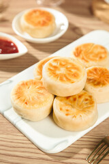 Traditional Chinese Steamed Dumplings with Dipping Sauce on Wooden Table