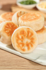 Chinese BBQ Pork Buns with Crispy Golden Pastry - Traditional Beijing Dim Sum Cake on White Plate