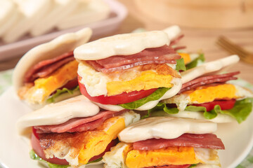 Wrapped Club Sandwiches with Bacon and Eggs on Wooden Table Background