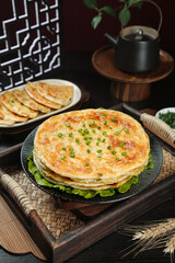 Handmade Layered Scallion Pancakes with Green Onions and Traditional Tea Setting