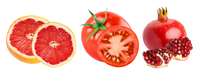 selection of vibrant red fruits and vegetables including sliced pink grapefruit, whole tomato, and whole and seeded pomegranate, isolated on black.