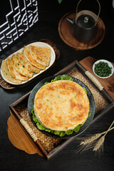 Handmade Golden Scallion Pancakes with Fresh Green Onions on Rustic Wooden Serving Trays