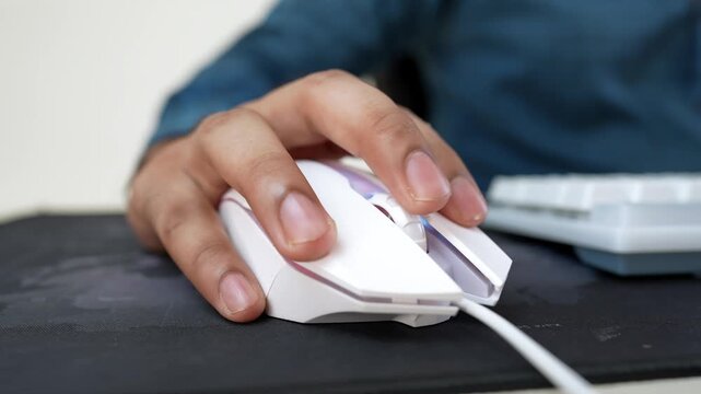 Hand Using White Computer Mouse on Black Mousepad