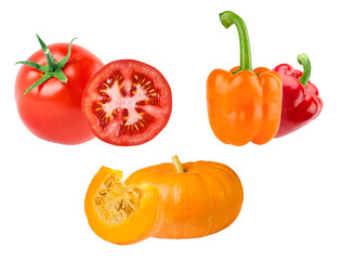 assorted fresh harvest of colorful vegetables including ripe red tomato, bell peppers, and sliced pumpkin, isolated on black.