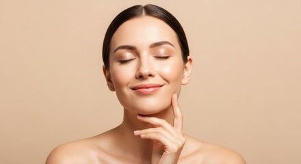 Young woman with eyes closed touching chin, relaxed and calm expression isolated on beige