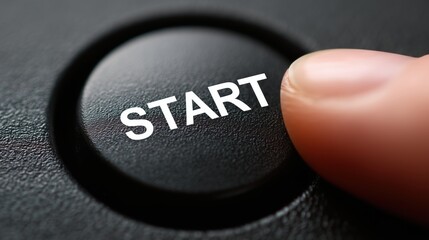 Finger is about to push the black round start button to initiate action