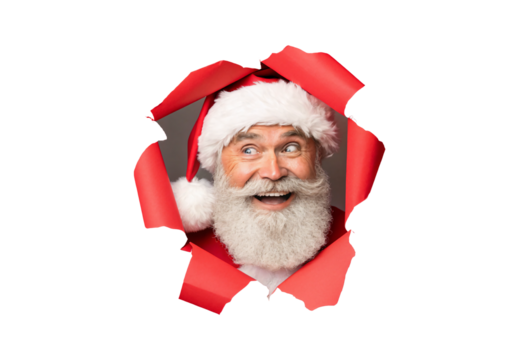 Jolly Santa peering through torn red wrapping paper with excited face and fluffy beard, isolated on a transparent background