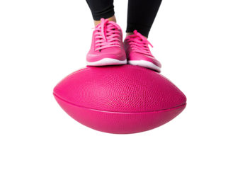 Pink sneakers balanced on textured balance trainer dome for fitness exercise, isolated on a transparent background