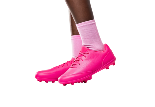 Hot pink football cleats with molded studs, worn with light pink socks, isolated on a transparent background