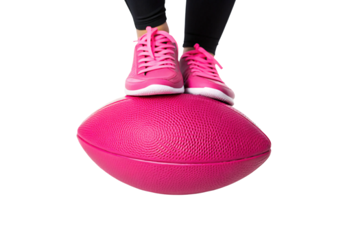 Pink sneakers balanced on textured balance trainer dome for fitness exercise, isolated on a transparent background