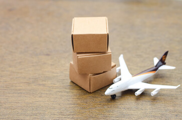 Air Freight & Global Logistics: A miniature cargo plane next to stacked boxes, symbolizing international shipping and package delivery.