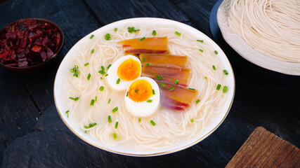 Fresh Handrolled Noodles Ramen Bowl with Soft Boiled Eggs and Pork - Traditional Asian Soup