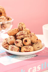 Xinjiang Red Jujube Dates on White Plate Pink Background Chinese Dried Fruit Healthy Snack Food Photography