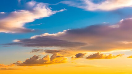 Fototapeta premium Vibrant sunset sky with golden clouds creates a peaceful and uplifting feeling in nature's beauty