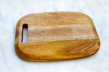 Wooden cutting board on grey background.