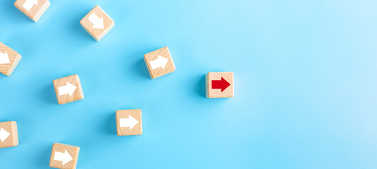 Naklejka premium Business competition, leadership concept. wooden blocks with red arrow on blue background