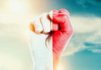 Malta national flag fist raise in the sky. The hand with flag raise in beautiful soft sky. Malta national flag for independence day.