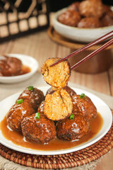 Braised Meatballs in Sauce with Chopsticks - Asian Cuisine Special Dish