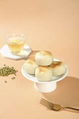 Traditional Mung Bean Cakes on Cake Stand - Asian Pastry Dessert Display with Tea