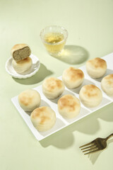 Traditional Green Bean Mochi Cake Desserts with Tea on Pastel Background