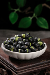 Fresh Black Beans with Green Sprouts in White Bowl on Wooden Table