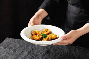 Steamed Golden Abalone Seafood Dish Presented by Chef in Restaurant Kitchen